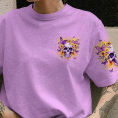 a woman with tattoos wearing a purple shirt