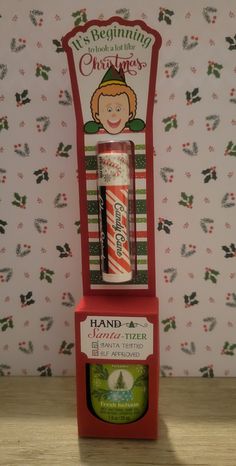 an old fashioned christmas candy dispenser with a stick in it's display case