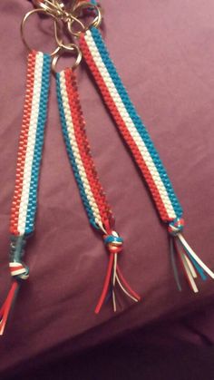 two red, white and blue lanyards with tassels attached to them