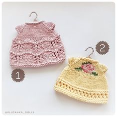 two crocheted sweaters with flowers on them, one is pink and the other is yellow