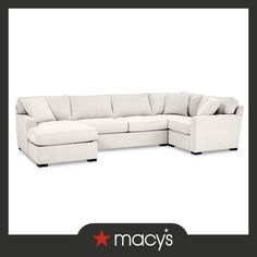 a white sectional couch with pillows on it