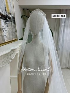 a mannequin wearing a wedding dress with a veil