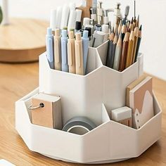 a pen holder filled with lots of pens and pencils