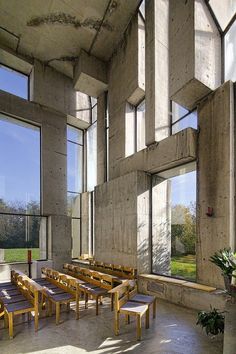 an empty room with benches and large windows