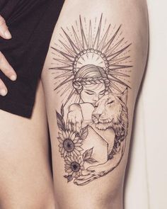 a woman's thigh with a tattoo on it that has a wolf and sunflowers