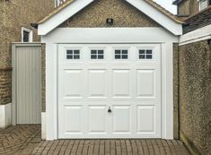 a white garage door on the side of a house