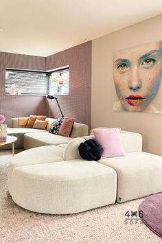 a living room filled with furniture and a large painting on the wall above it's head