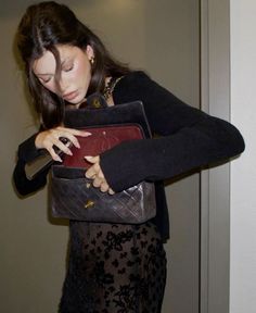 a woman holding a purse in her hands