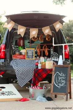 the back end of a van is decorated with black and white checkered tablecloths