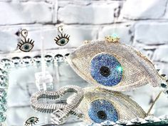 Gorgeous Rhinestone women’s clutch ! the perfect statement accessory  to sparkle your outfit.THIS IS NOT SOLD AS A SET Chocker and earrings available on a separate listing.🧿4.5”H X 7.5”W 🧿Chain 19”Follow us in Instagram: @kyboutique4SHARE YOUR PICTURES IN INSTAGRAM #kyboutique4Website: Visit un also on the webwww.kyboutique4.comPlease make sure to read my Shipping Terms & Conditions Information prior to making a purchase:https://www.etsy.com/shop/Kyboutique4/policy Sparkling Evening Bag For Gifts, Silver Sparkling Clutch For Gift, Bling Crystal Clutch As Gift, Luxury Crystal Clutch As Gift, Luxury Crystal Clutch For Gift, Silver Bling Clutch For Gift, Crystal Clutch With Bling As Gift, Crystal Clutch With Bling For Gifts, Elegant Evil Eye Jewelry For Party