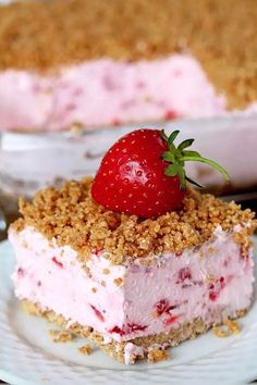 a piece of strawberry ice cream pie on a white plate with a strawberries garnish