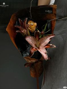 a woman holding a bouquet of flowers in her hand