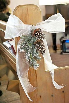 a wooden chair with a pine cone tied to it