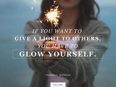 a woman holding a sparkler in her hand with the quote if you want to give a light to others, you have to glow yourself