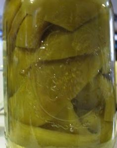 a jar filled with pickles sitting on top of a counter