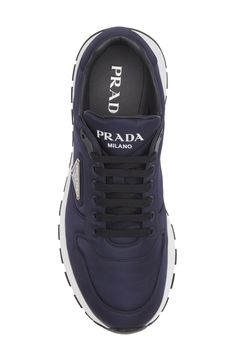 Prada takes a sustainable step with this runner-inspired sneaker partially made from Re-Nylon, an industrial-inspired textile that can be endlessly regenerated. Recycled-nylon upper/recycled-polyester and synthetic lining/rubber sole Made in Italy Men's Designer Shoes Luxury Nylon Sneakers For Streetwear, Luxury Technical Nylon Sneakers, Prada Sport Shoes, Prada Nylon Re Edition, Prada Formal Shoes Men, Mens Designer Shoes, Navy Shoes, Prada Men, Sneaker Men