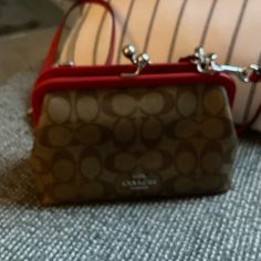 Coach Womens Kisslock Crossbody. Signature Coated Canvas And Smooth Leather Inside Multifunction Pocket, Kisslock Closure, Fabric Lining, Detachable Strap With 22 3/4" Drop For Shoulder Or Crossbody Wear 8 1/2" (L) X 5 1/2" (H) X 3" (W) Luxury Red Bag With Snap Closure, Red Crossbody Bag With Snap Closure, Chic Red Bag With Snap Closure, Brown Leather Crossbody Bag, Coach Crossbody Purse, Bags Coach, Brown Crossbody, Canvas Crossbody Bag, Purple Suede