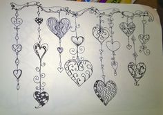 a drawing of hearts hanging from a line on a piece of paper with colored crayons in the background