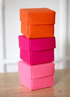 four pink and orange boxes stacked on top of each other in the shape of cubes