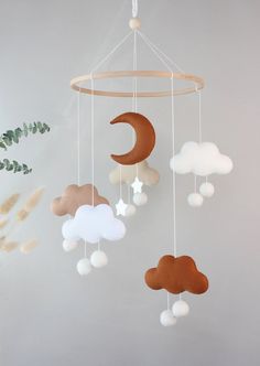 a mobile with clouds and a crescent hanging from it