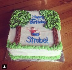 a birthday cake that is sitting on top of a wooden table with the words happy birthday strobe