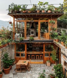 an outdoor bar with potted plants on the roof