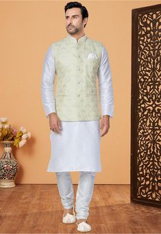 Art Dupion Silk Kurta in White This Chinese Collar Neck and Full Sleeve attire is Enhanced with Buttons, Pockets, Resham and Sequins Work Available with an Art Dupion Silk Churidar in White and an Art Silk Nehru Jacket in Pastel Green Do note: Footwear shown in the image is for presentation purposes only. Half to one inch may vary in measurement. (Slight variation in actual color vs. image is possible) Nehru Jacket With Kurta, Silk Kurta Set, Gents Kurta Design, Pista Green, Gents Kurta, Chinese Collar, Fancy Buttons, Designer Anarkali, Nehru Jacket