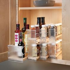 an organized spice rack with spices and condiments on it in a kitchen cabinet