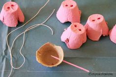 some pink marshmallows are sitting on a blue surface and there is a string in front of them