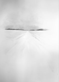 a black and white photo of an airplane flying in the sky over snow covered ground