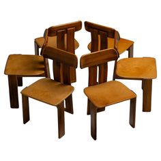 four wooden chairs sitting next to each other