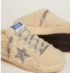 These Super-Star sneakers feature an upper in soft natural white shearling embellished with a silver glitter star. The ice-gray laces with contrasting black logo complete the look. Natural white shearling upper Silver glitter star Ice-gray laces with contrasting black logo Vintage finish Upper: 97% sheepskin leather, 2% polyethylene terephthalate, 1% cotton Lining: 75% sheepskin leather, 25% cow leather Sole: 100% rubber Made in Italy Goose Craft, Golden Family, Ice Star, Dad Sneakers, Gorgeous Couple, Logo Vintage, Golden Goose Deluxe Brand, Glitter Stars, Girl Running