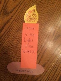 a piece of paper with a candle on it that says jesus is the light of the world