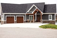 a large house with two garages on each side