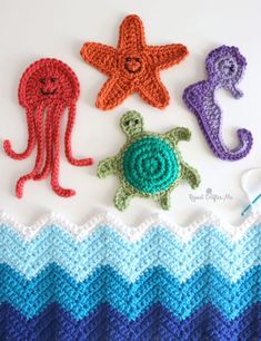 three crocheted sea animals and one turtle