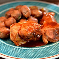 meatballs and gravy on a blue plate