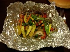 a foil covered plate with vegetables on it