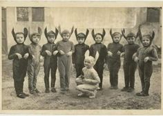 a group of children wearing bunny ears standing next to each other in front of an old photo