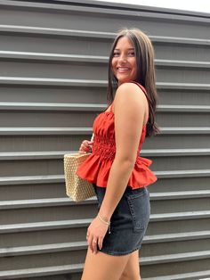 our harli tank is a solid reddish / rustic orange shirred button down tank top:: perfect for concerts, july 4th celebrations or as a fun everyday summer top! made with a flirty fit and flare design with its ruched waist and ruffle hem. add some shape to your look with this easy piece! shop more tops! sizing, details & care model sizingHolley is 5'3" 125lbs with a 34" bust, 31" waist and 35" hip wearing a smallDee is 5'5" 135lbs wearing a smalldetails- 97% cotton, 3% elastane care- hand wash cold Summer Vacation Tank Top With Smocked Bodice, Summer Beach Tank Top With Smocked Back, Flirty Ruched Tops For Summer, Summer Tank Top With Smocked Back, Flirty Sleeveless Tops For Summer, Fitted Flirty Smocked Top For Day Out, Casual Spring Tank Top With Smocked Back, Chic Orange Tank Top For Summer, Summer Vacation Top With Smocked Back