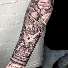 a man's arm with an image of the planets on it