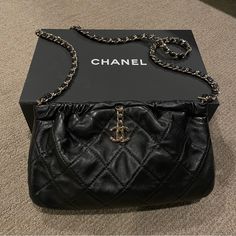 *England Exclusive Rare Chanel! Purchased March 2022 From London* Like New Condition!! Purchased With Tax For About $4900.00. No Low Balls. 100% Authentic And Only Worn Once! In Mint Condition With No Damages, Scratches, Or Sign Of Wear. Lambskin Leather Quilted Design. Has A Chanel Metal Logo Hanging In The Front, With A Leather Pull Tab In The Back. In Order To Open The Bag You Pull The Chain Logo And The Pull Tab. To Close The Bag You Just Push It Back And It Closes. Metal Hardware Is A Silver/Champagne Tone. Very Beautiful Sheen To The Lambskin Leather. Has The Plastic Seal Still Over The Authenticity Code Inside. Can Be Worn As A Crossbody Or Shoulder Bag Style. Comes With Full Pack Chain Logo, Push It, Gold Chanel, Bag Style, Metal Logo, Chanel Black, Leather Pulls, Exclusive Bag, Metallic Logo