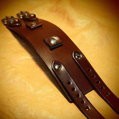 "This Brown leather cuff is2.25\" wide cuff is custom hand dyed in a rich brown finish . It features two 3/4\" watch connectors and uses two 5/8\" straps. Two top quality stainless steel buckles and hand polished rivets provide the closure A great width for any wrist! This cuff is inspired by the early Johnny Depp cuffs. can be used with or without a watch! I'll need your wrist size for this cuff! Please use the instructions in the pics above! Thanks for checking out my work! I use a fine hand i Vintage Brown Adjustable Watch Band, Handmade Brown Cuff Bracelet, Adjustable Vintage Cuff Bracelet With Wrist Strap, Adjustable Cuff Bracelet With Custom Hardware, Brown Leather Strap Cuff Bracelet, Brown Adjustable Cuff Watch Band, Adjustable Brown Cuff Watch Band, Adjustable Brown Leather Bracelet With Custom Hardware, Brown Bracelets With Custom Hardware For Gift