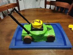 a cake made to look like a car on a blue plate with yellow icing