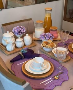 a table set for two with dishes and cups