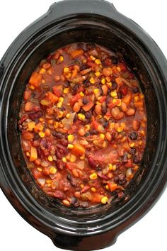 a crock pot filled with beans and corn