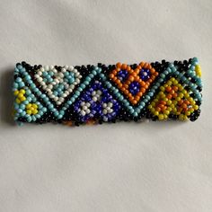 a beaded bracelet with multicolored beads on white background, close up view