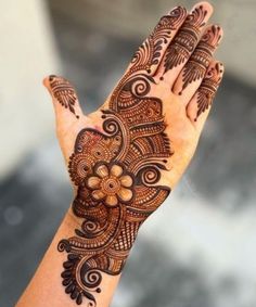 a woman's hand is decorated with hennap and intricate designs on it