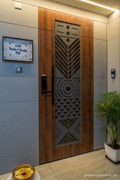 a wooden door with an intricate design on the front and side panels is shown in this modern entryway