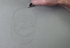 someone is drawing something on the paper with a pencil