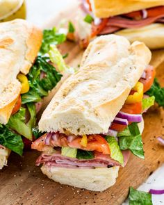 a cut in half sandwich sitting on top of a cutting board